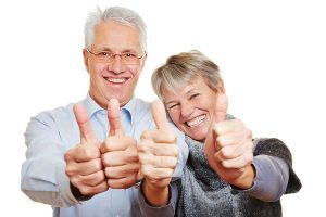 Happy Senior couple showing thumbs up because SSN is removed fromved from their Medicare id cards
